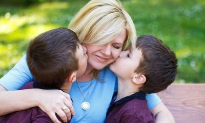 40168479-mother-with-two-sons-in-park-on-bench-boys-hug-mom